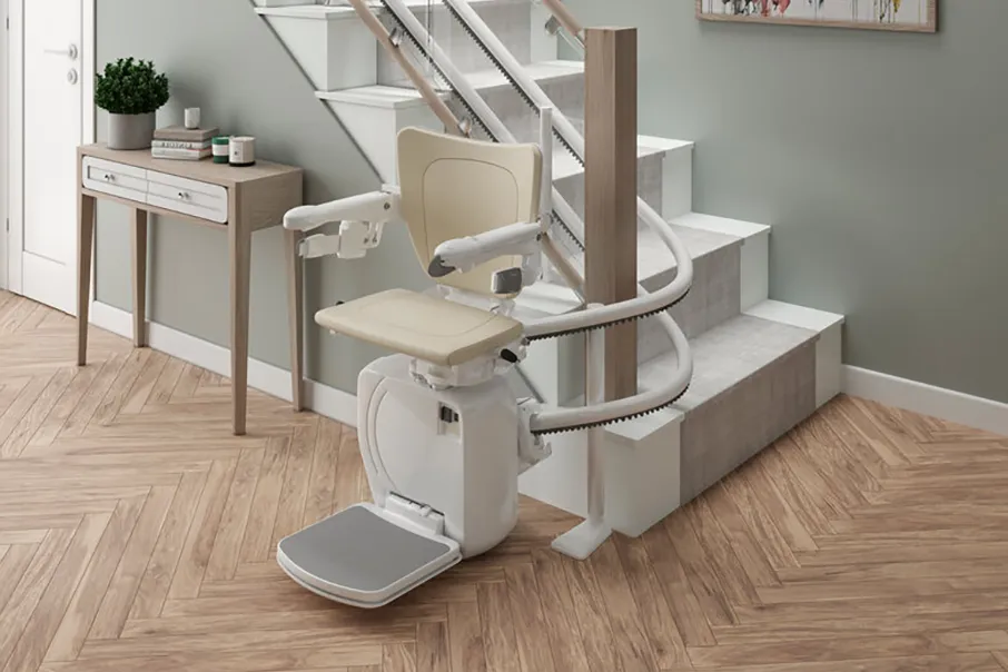 A Freedom Stairlifts Curved Stairlift 2 with natural colour upholstery open wrapping 180 degrees at the foot of the stairs