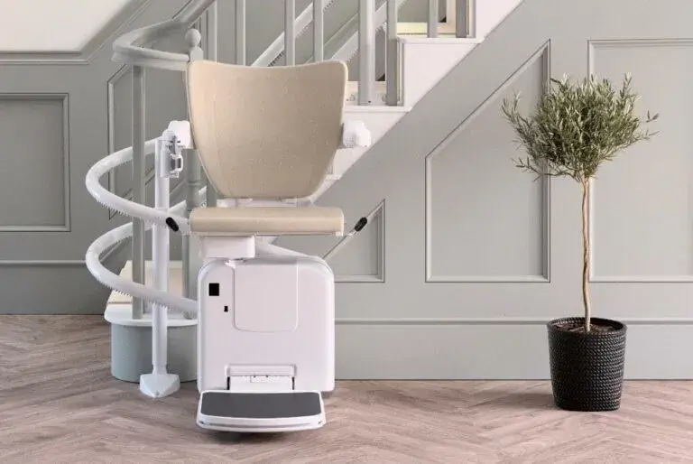 Facing a Freedom Stairlifts Curved Stairlift 2 with natural colour upholstery in the open position at the foot of the stairs wrapping around 180 degrees.