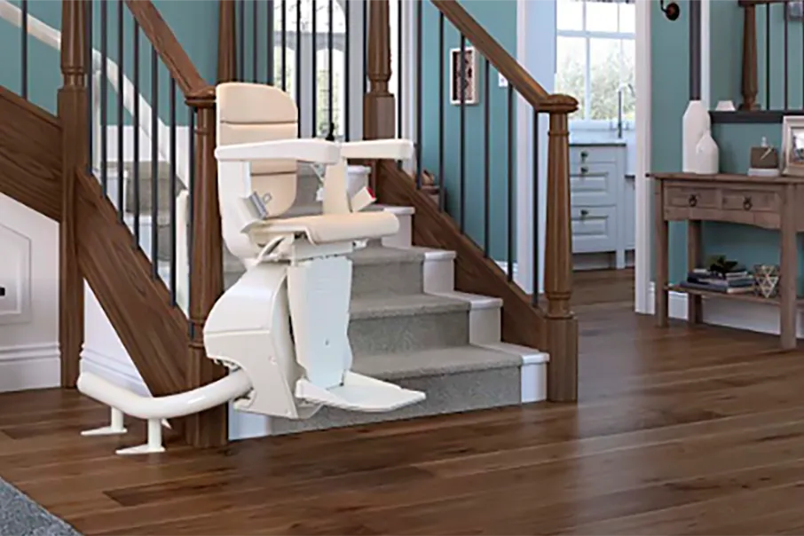 A Freedom Stairlifts curved Stairlift 3 ascending the stairs on an internal bend by using the stairlift remote control.