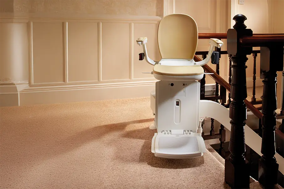 Freedom Stairlifts single track Curved Stairlift 4 with cream upholstery at the top of the stairs
