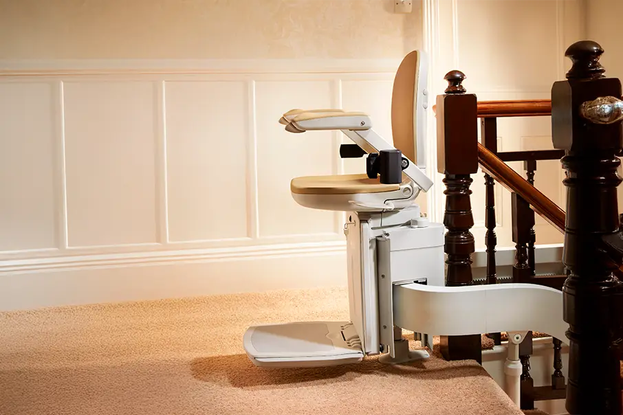 A Freedom Stairlifts single track curved Stairlift 4 with cream colour upholstery and a 180 top overrun onto the landing of one metre