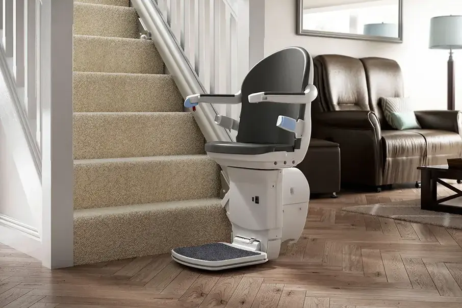 Freedom Stairlifts Straight Stairlift 3 in the opened position at the bottom of the stairs with a slate coloured seat