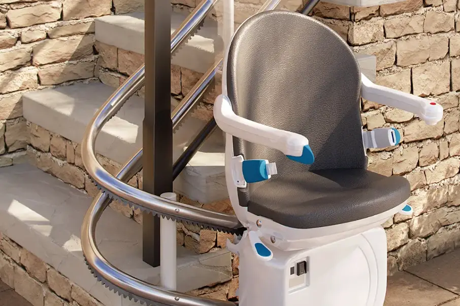 Close up view of a Freedom Stairlifts Outdoor Straight Stairlift in light coloured upholstery open at the foot of the stairs